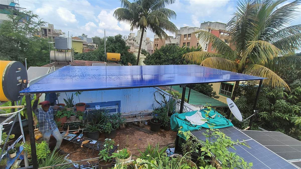 A sturdy polycarbonate roofing shed installed over a residential terrace.